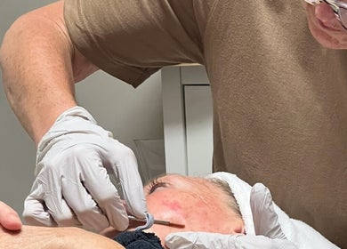 Skincare expert performing a facial treatment at Youthful Glow Aesthetics in Munford, Tennessee, US.