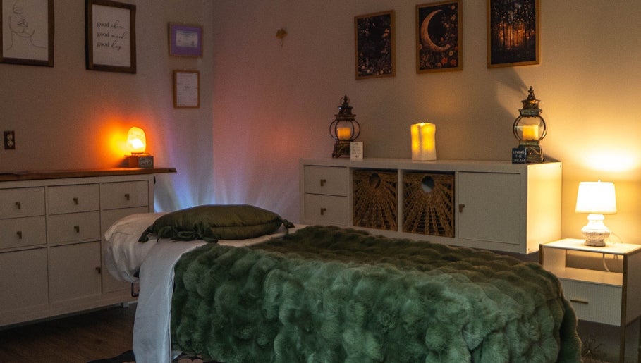 Tranquil massage room at Youthful Glow Aesthetics, Munford, Tennessee, US, with soft lighting and cozy decor.