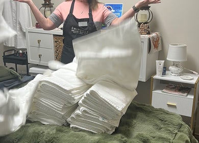 Youthful Glow Aesthetics staff with neatly folded towels in Munford, Tennessee, US. A welcoming spa atmosphere.