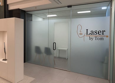Entrance of Laser by Tom in Bondi Junction, New South Wales, AU with modern glass doors and chic decor.