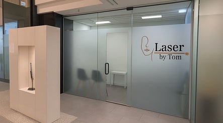 Entrance of Laser by Tom in Bondi Junction, New South Wales, AU with modern glass doors and chic decor.