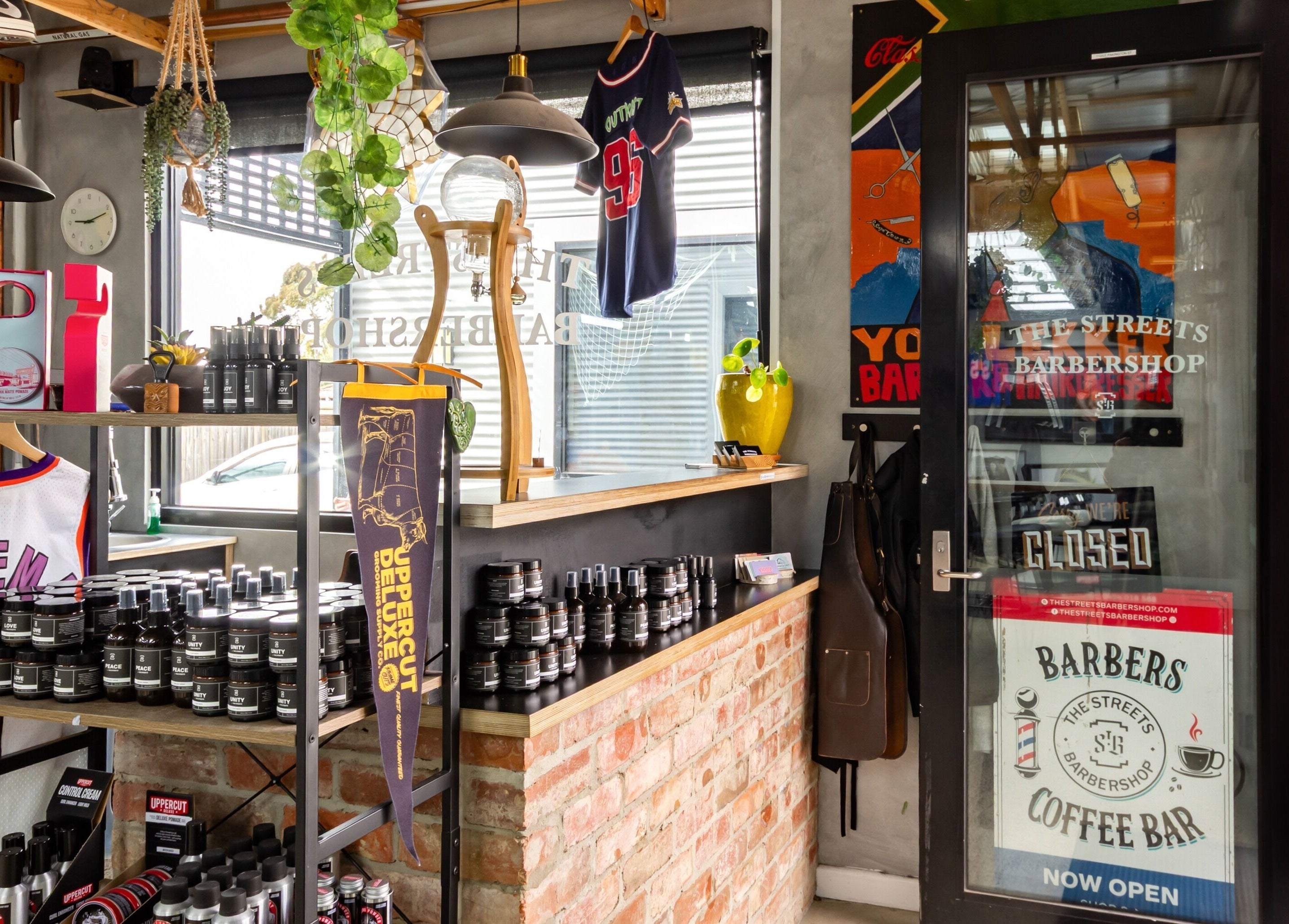 Hip interior of The Streets Barbershop in Geelong West, Victoria, AU showcasing products and decor.