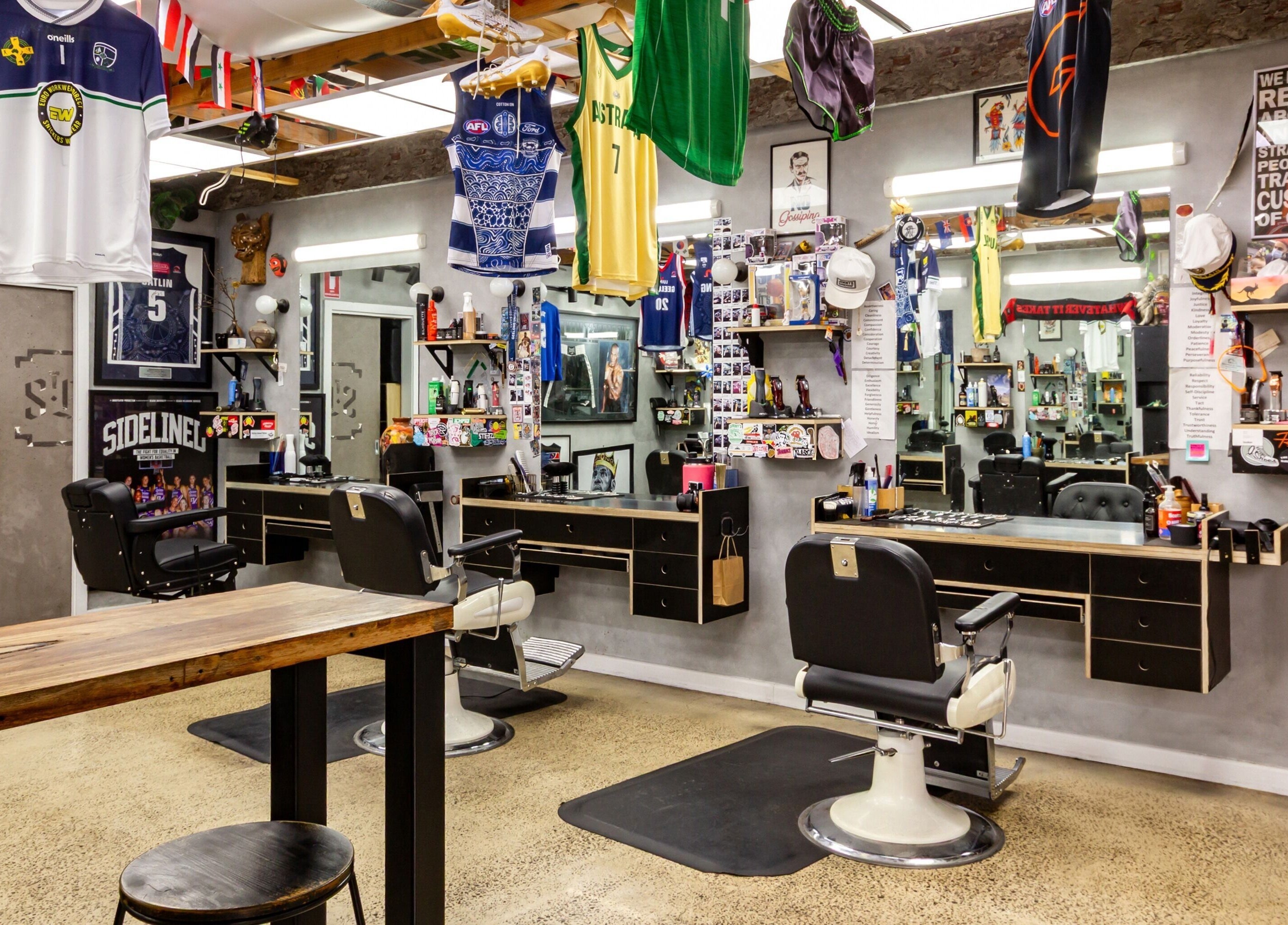 Inside The Streets Barbershop, Geelong West, Victoria, AU showcasing modern chairs and sports-themed decor.