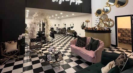 Chic and elegant salon interior at The Curl Station in Liverpool, England, GB, featuring plush seating and stylish decor.