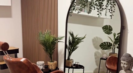 Stylish salon interior with mirror and plants at The Curl Station, Liverpool, England, GB.