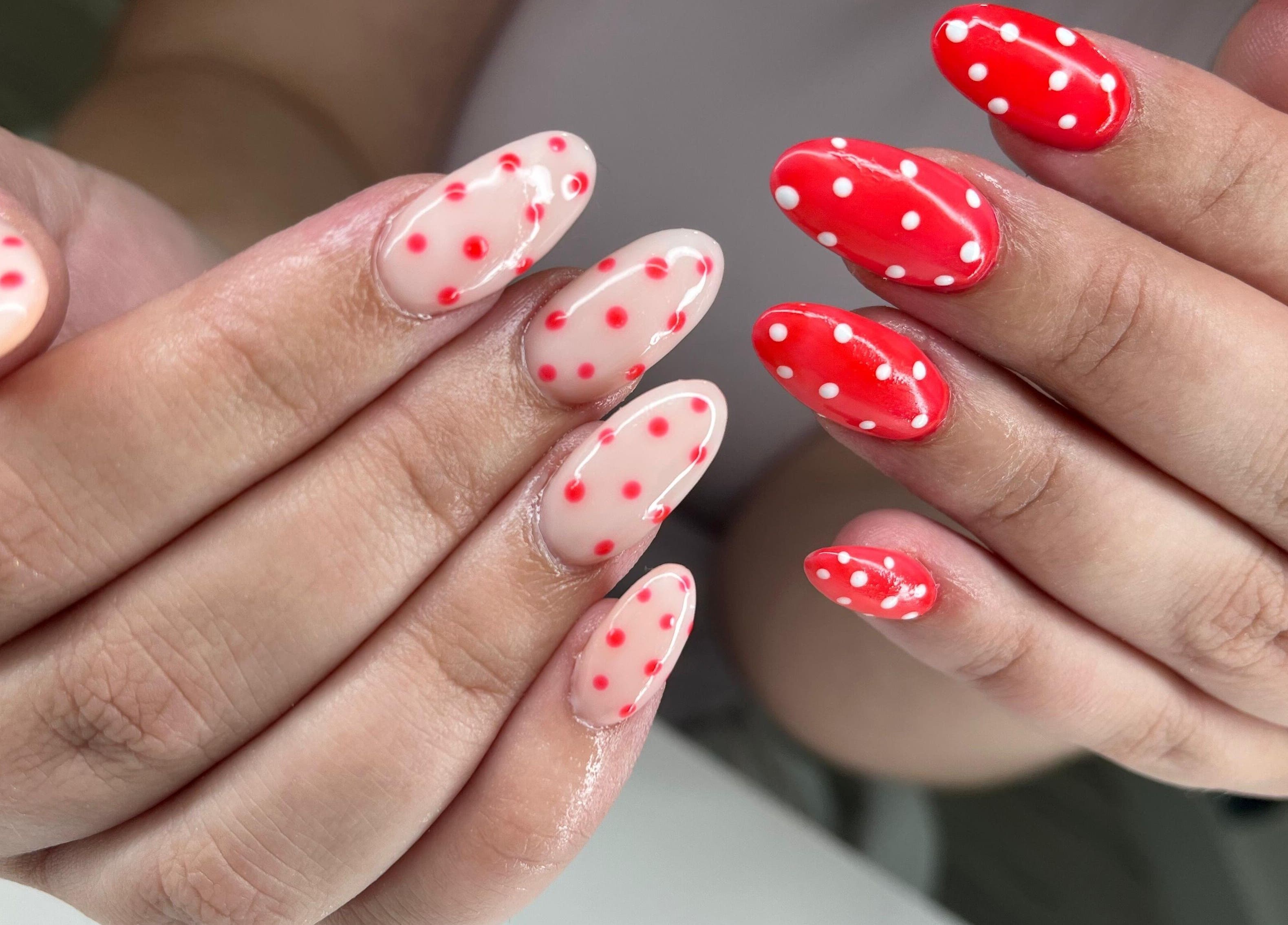 Polka dot nail art at Glow Gang Studio in Cape Town, Western Cape, ZA showcases vibrant red and white designs.