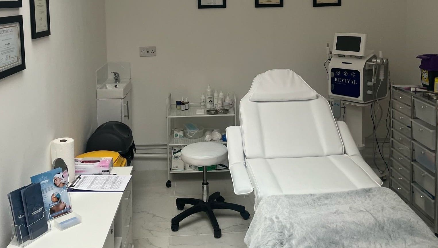 Ice London Aesthetics Clinic treatment room in Beckenham, England, featuring a plush white chair and equipment.