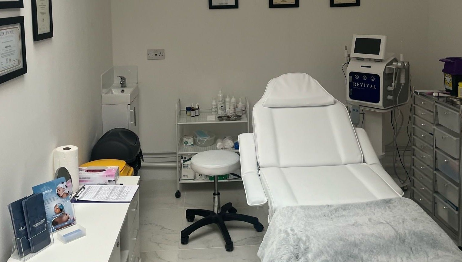 Ice London Aesthetics Clinic treatment room in Beckenham, England, featuring a plush white chair and equipment.