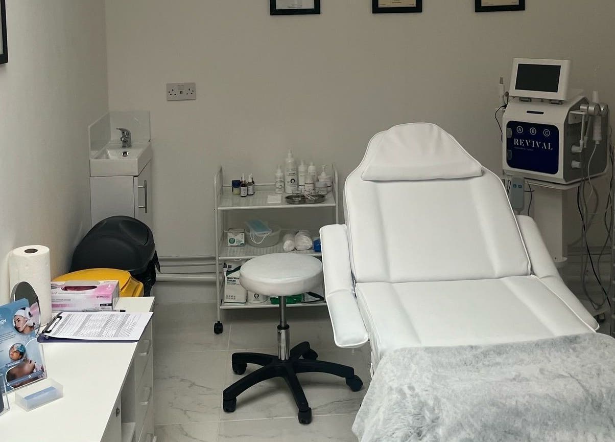 Ice London Aesthetics Clinic treatment room in Beckenham, England, featuring a plush white chair and equipment.