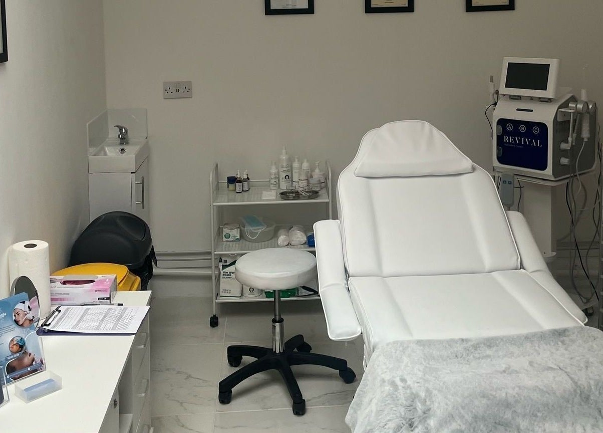 Ice London Aesthetics Clinic treatment room in Beckenham, England, featuring a plush white chair and equipment.