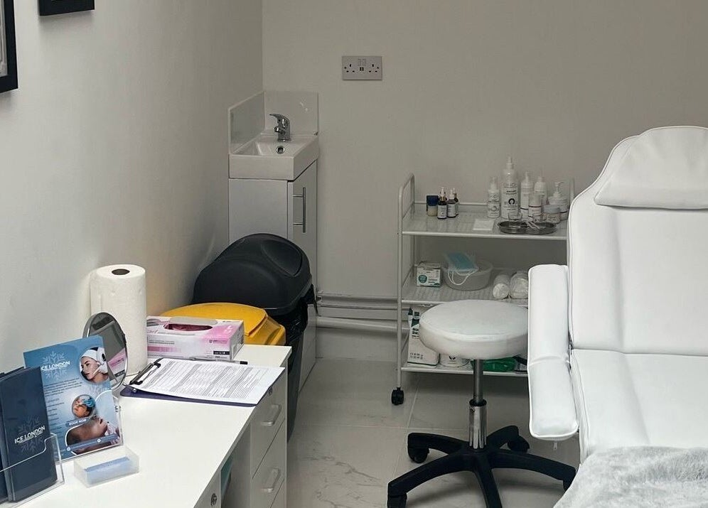 Elegant treatment room at Ice London Aesthetics Clinic, Beckenham, England, GB with white chair and equipment.