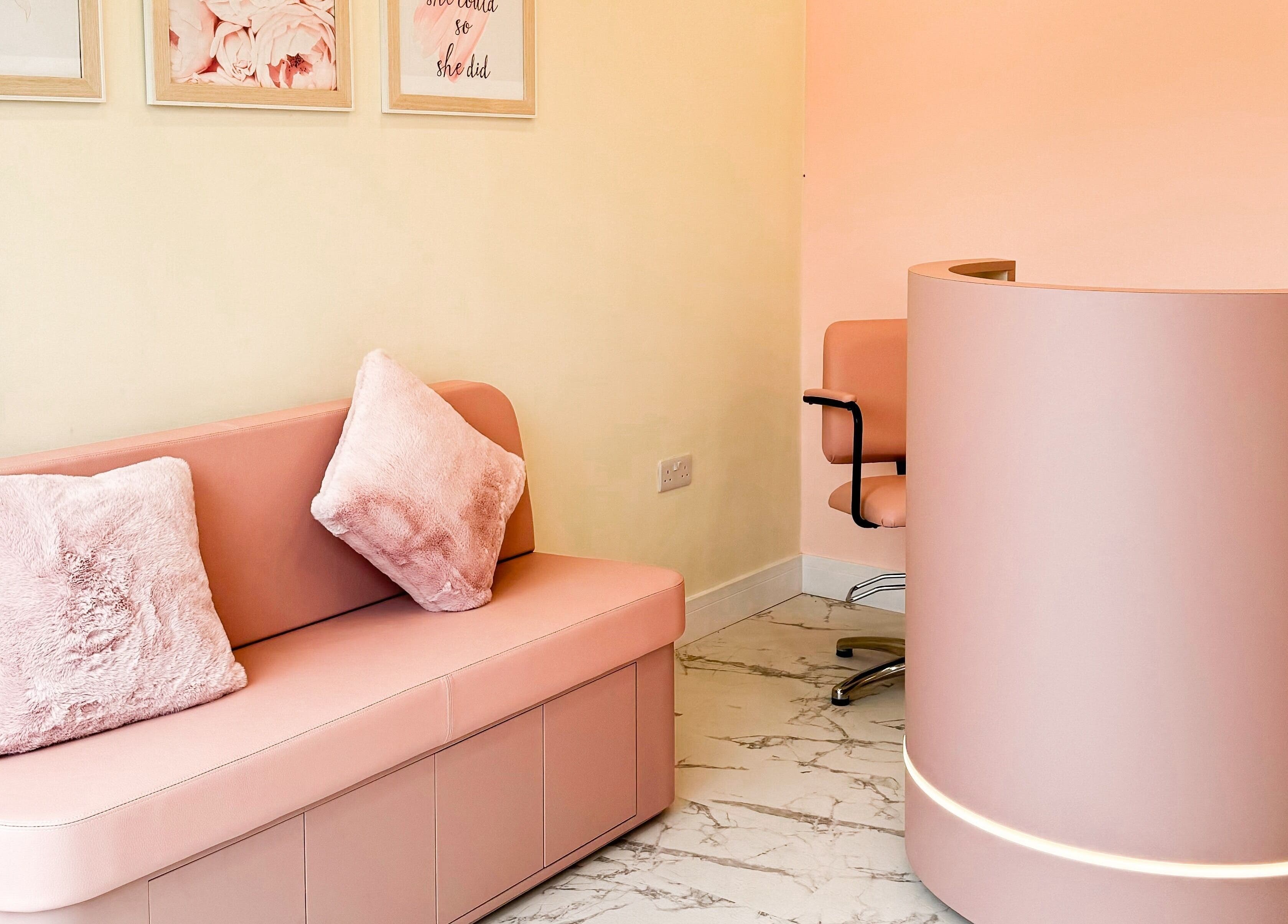 Elegant pink reception and seating area at GK Beauty in Maltby, England, GB, showcasing modern decor.