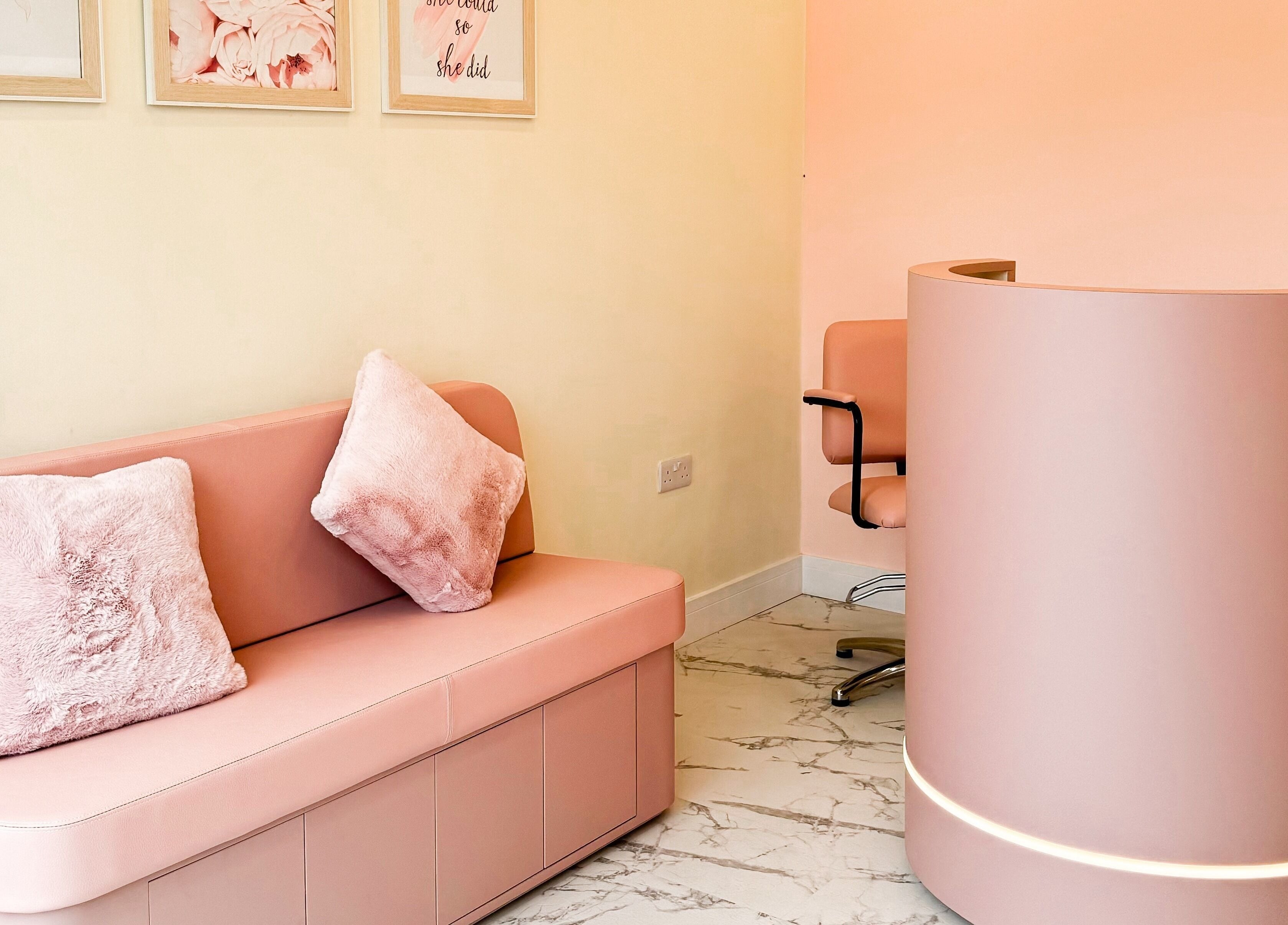 Elegant pink reception and seating area at GK Beauty in Maltby, England, GB, showcasing modern decor.