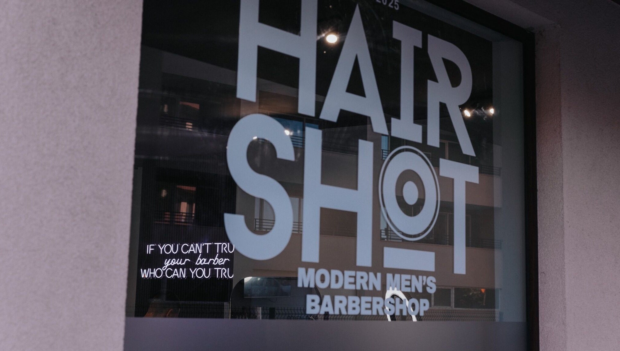 Hairshot storefront window in Plovdiv, Plovdiv, BG showing modern men's barbershop design.