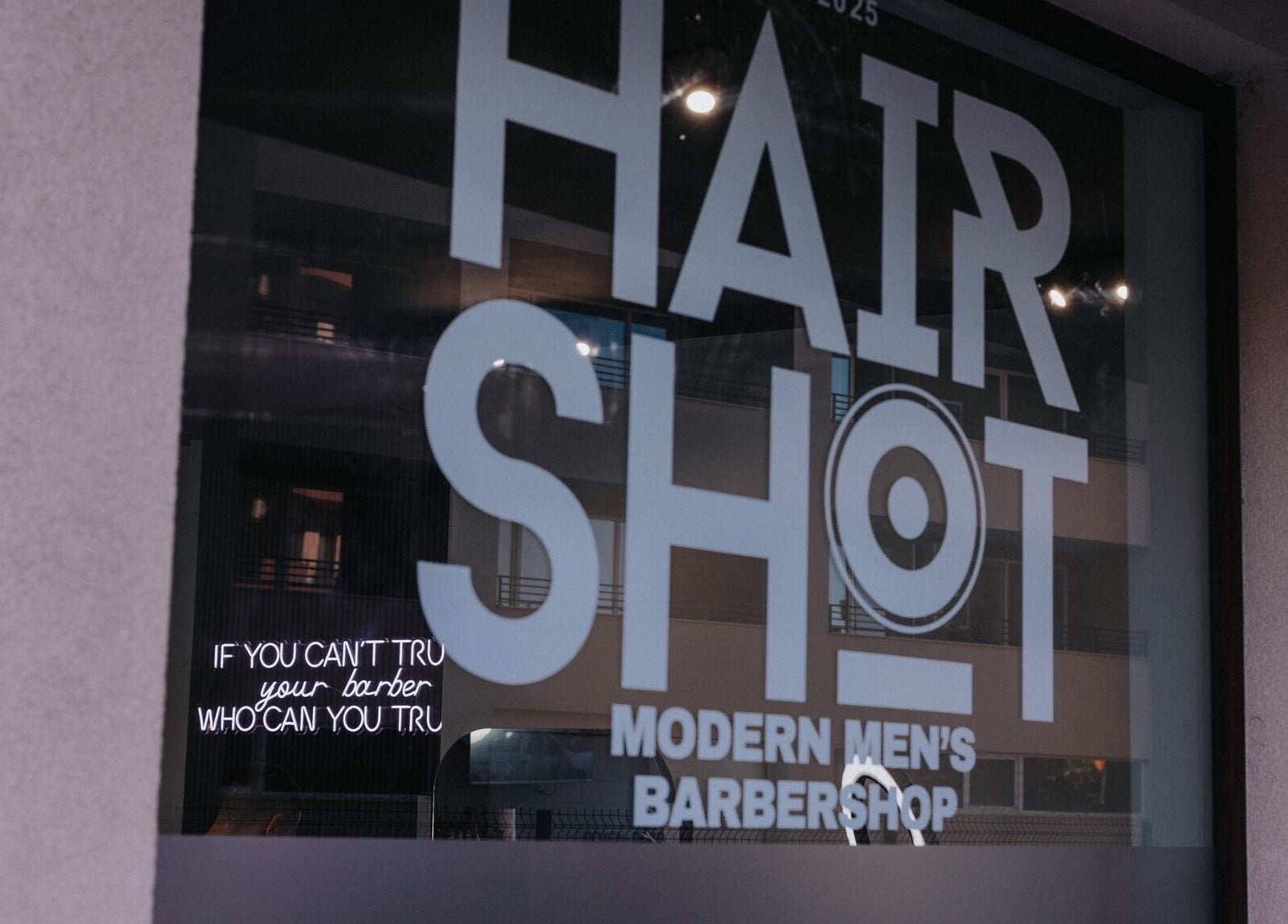 Hairshot storefront window in Plovdiv, Plovdiv, BG showing modern men's barbershop design.