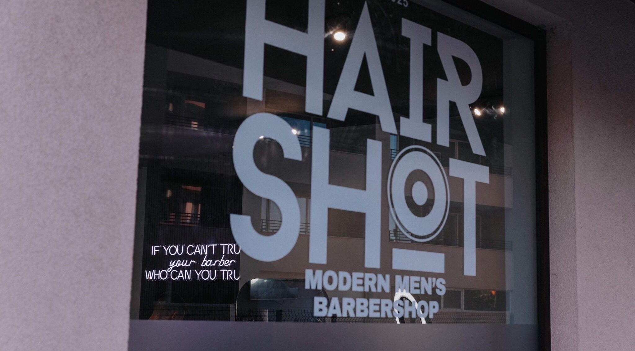Hairshot storefront window in Plovdiv, Plovdiv, BG showing modern men's barbershop design.