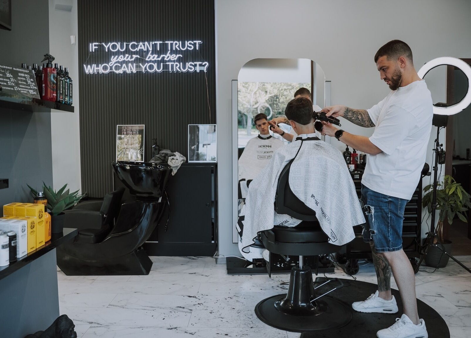 Expert barber at Hairshot in Plovdiv, Plovdiv, BG giving a precise haircut inside a modern salon.