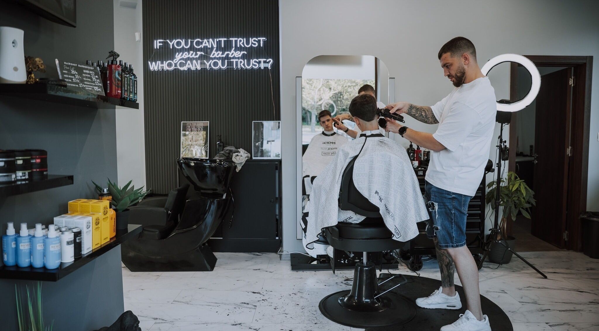 Expert barber at Hairshot in Plovdiv, Plovdiv, BG giving a precise haircut inside a modern salon.