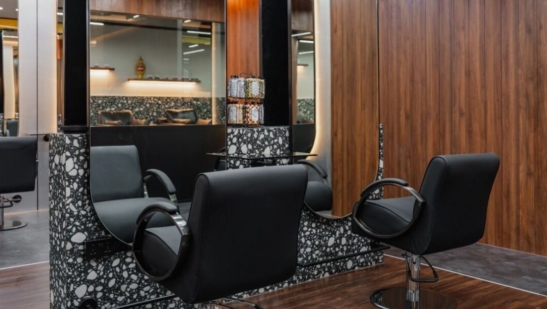 Modern salon at Elated in Abu Dhabi, AE featuring sleek black chairs and stylish decor.