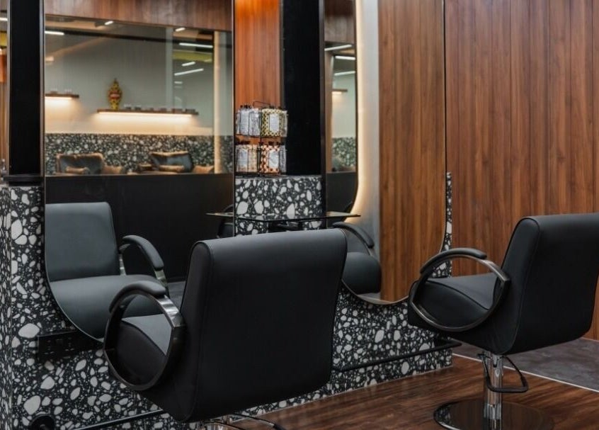 Modern salon at Elated in Abu Dhabi, AE featuring sleek black chairs and stylish decor.