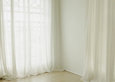 Sheer white curtains softly lit in The Light Loft, Hamilton, Waikato, NZ.