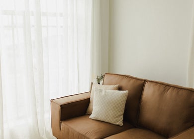 Elegant leather sofa by bright window at The Light Loft, Hamilton, Waikato, NZ.