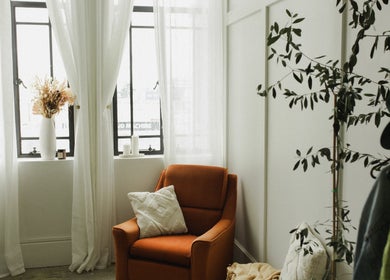 Bright and cozy nook at The Light Loft, Hamilton, Waikato, NZ with chair, pillow, and plants.