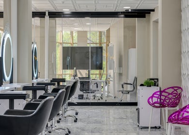 Chic interior of Tandi's Curls salon at Kellyville Ridge, New South Wales, AU with modern decor and styling chairs.