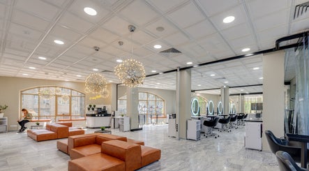 Spacious and modern interior of Tandi's Curls, Kellyville Ridge, New South Wales, AU with elegant salon chairs.