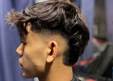 Trendy haircut for men at Aisy’s Cut, Gombak, Selangor, MY showcasing tapered sides and textured top.