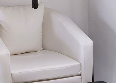 Elegant white chair in Posh Nail Lounge, Grand Anse, Grand Anse Praslin, SC, offering a serene relaxation nook.