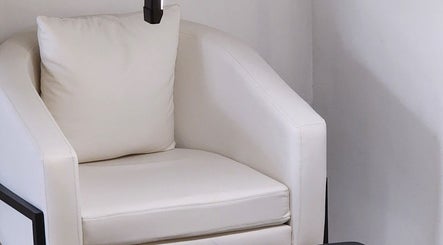 Elegant white chair in Posh Nail Lounge, Grand Anse, Grand Anse Praslin, SC, offering a serene relaxation nook.