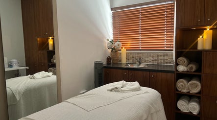 Spa treatment room at Tranquility By Catalin, Bridgend, Wales, GB with cozy setup and ambient lighting.