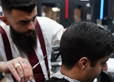 Barber crafting a sharp haircut at Wicked Barber, London, England, GB.