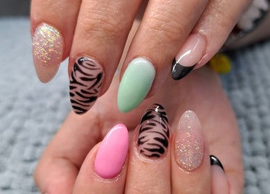 Colorful nail art design at Urban Nails At Jocelynn in Pretoria, Gauteng, ZA showcasing glitter and patterns.