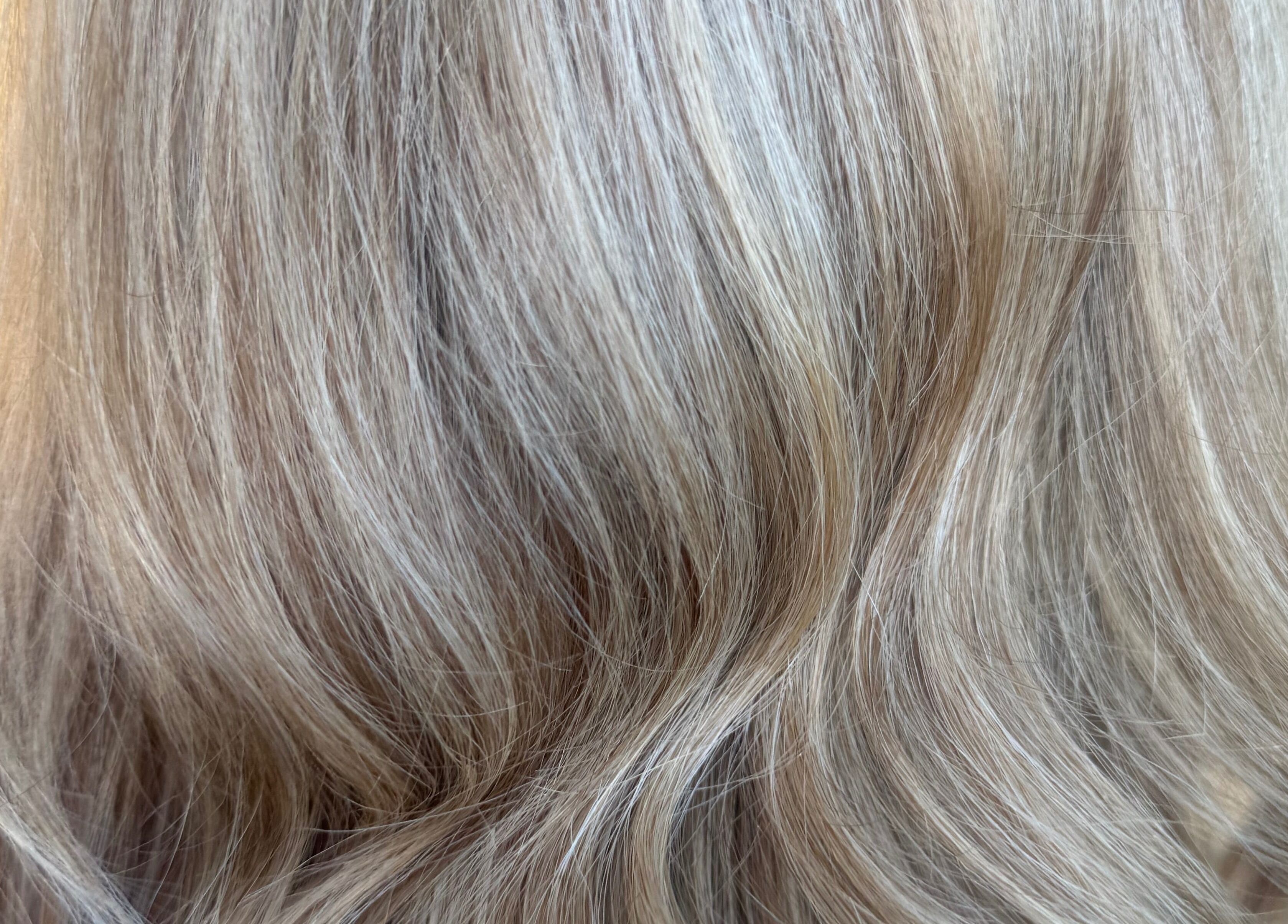 Elegant blonde hair with soft waves at Seventeen Shades, Ystrad Mynach, Wales, GB.