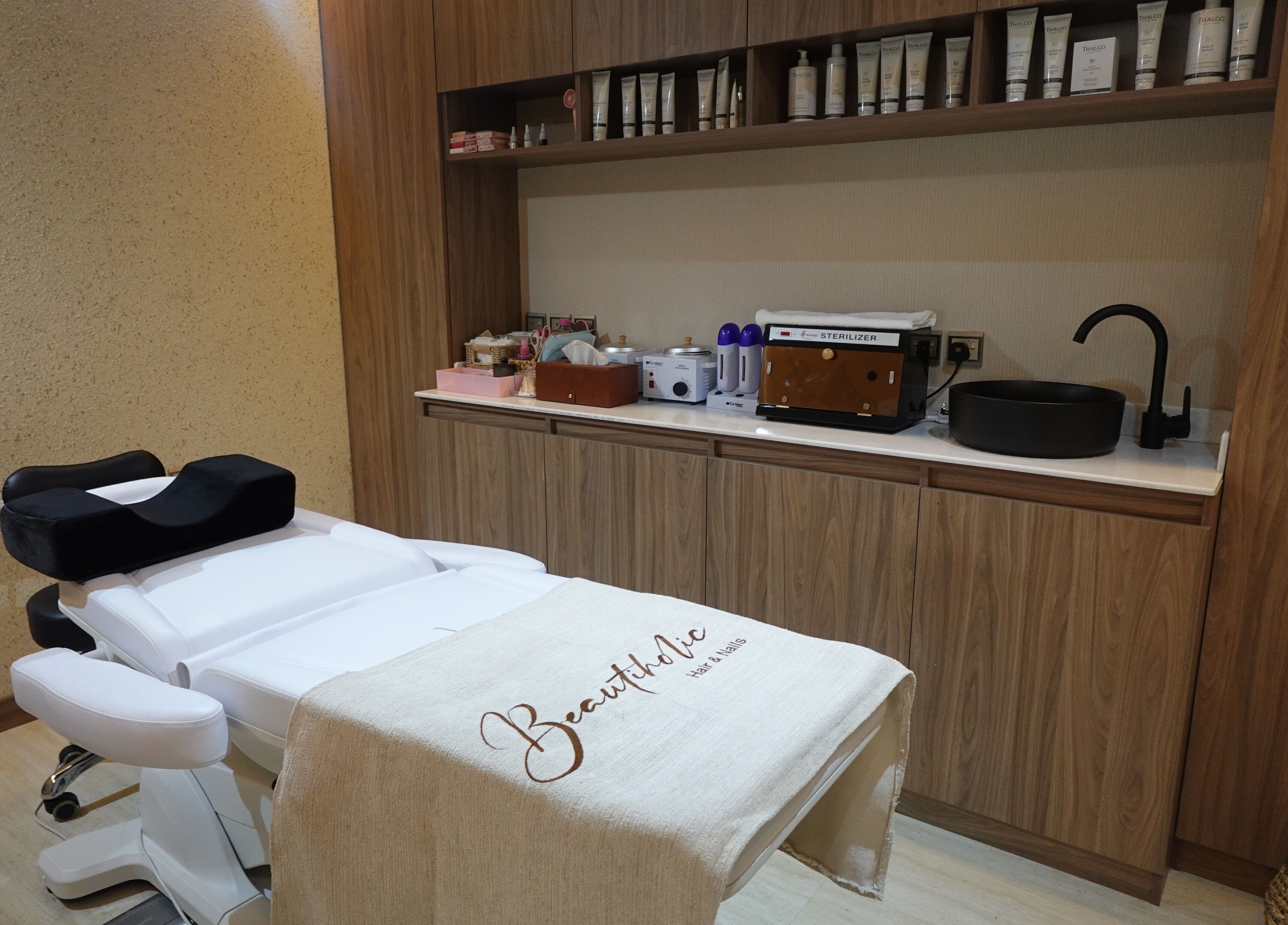 Treatment room at Beautiholic salon, Al Khobar, Eastern Province, SA, showcasing a modern setup and amenities.