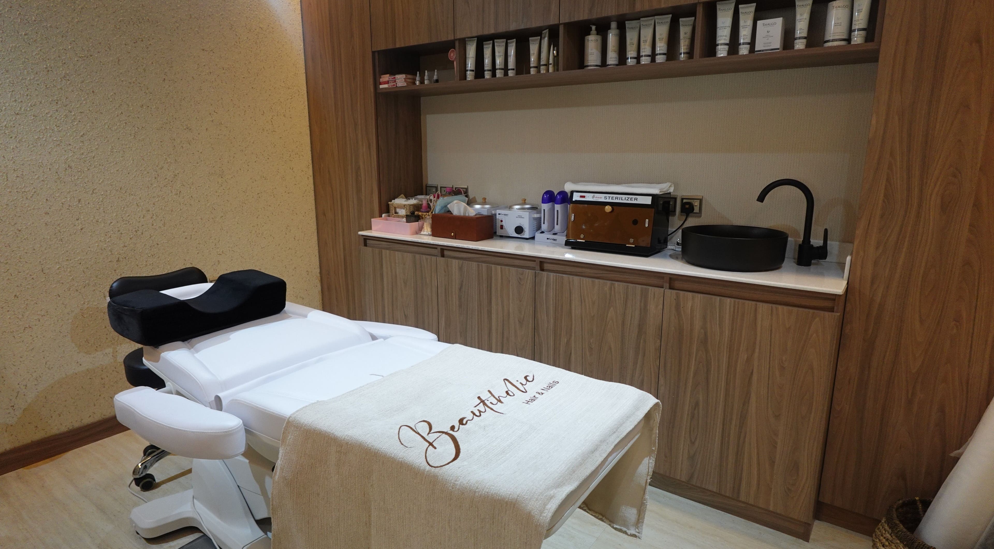 Treatment room at Beautiholic salon, Al Khobar, Eastern Province, SA, showcasing a modern setup and amenities.