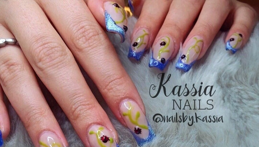 Elegant blue and yellow nail art at Kassia Nails, Raceview, Queensland, AU, showcasing intricate designs.