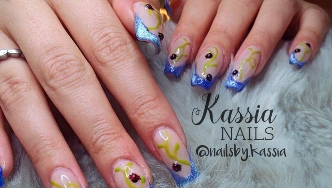Elegant blue and yellow nail art at Kassia Nails, Raceview, Queensland, AU, showcasing intricate designs.