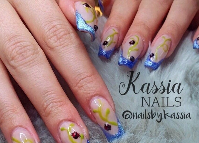 Elegant blue and yellow nail art at Kassia Nails, Raceview, Queensland, AU, showcasing intricate designs.