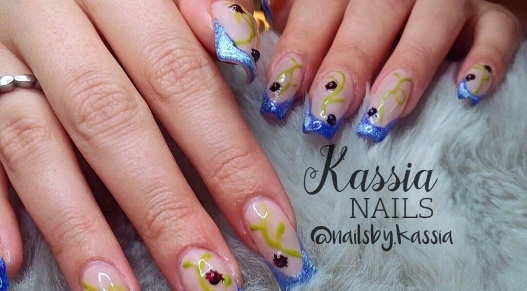 Elegant blue and yellow nail art at Kassia Nails, Raceview, Queensland, AU, showcasing intricate designs.