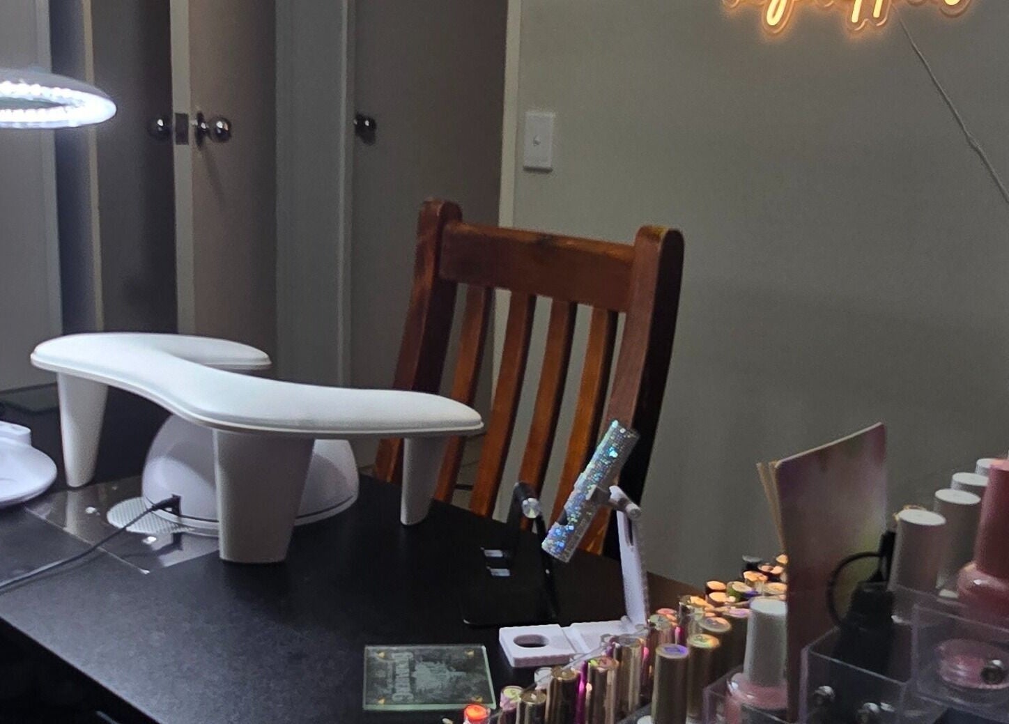 Elegant nail station at Kassia Nails in Raceview, Queensland, AU, showcasing vibrant polish selection and cozy setup.