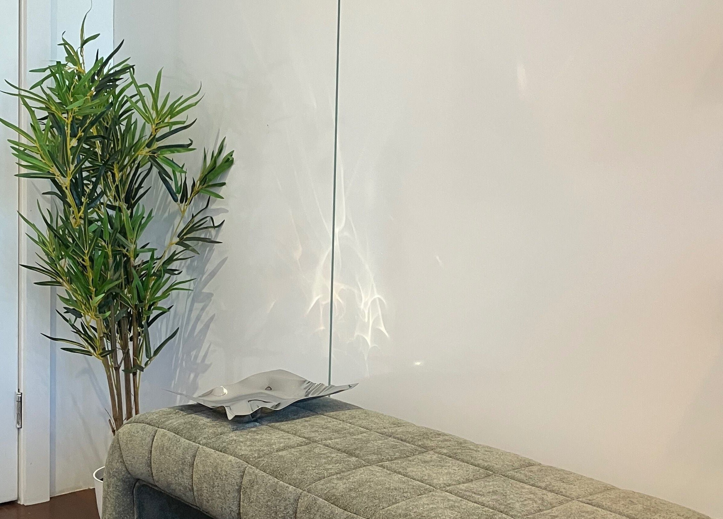 Tokyo Lash serene waiting area with plush seating and plant in Petersham, New South Wales, AU.