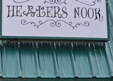 Healer's Nook Lacombe sign on green metal wall in Lacombe, Alberta, CA.