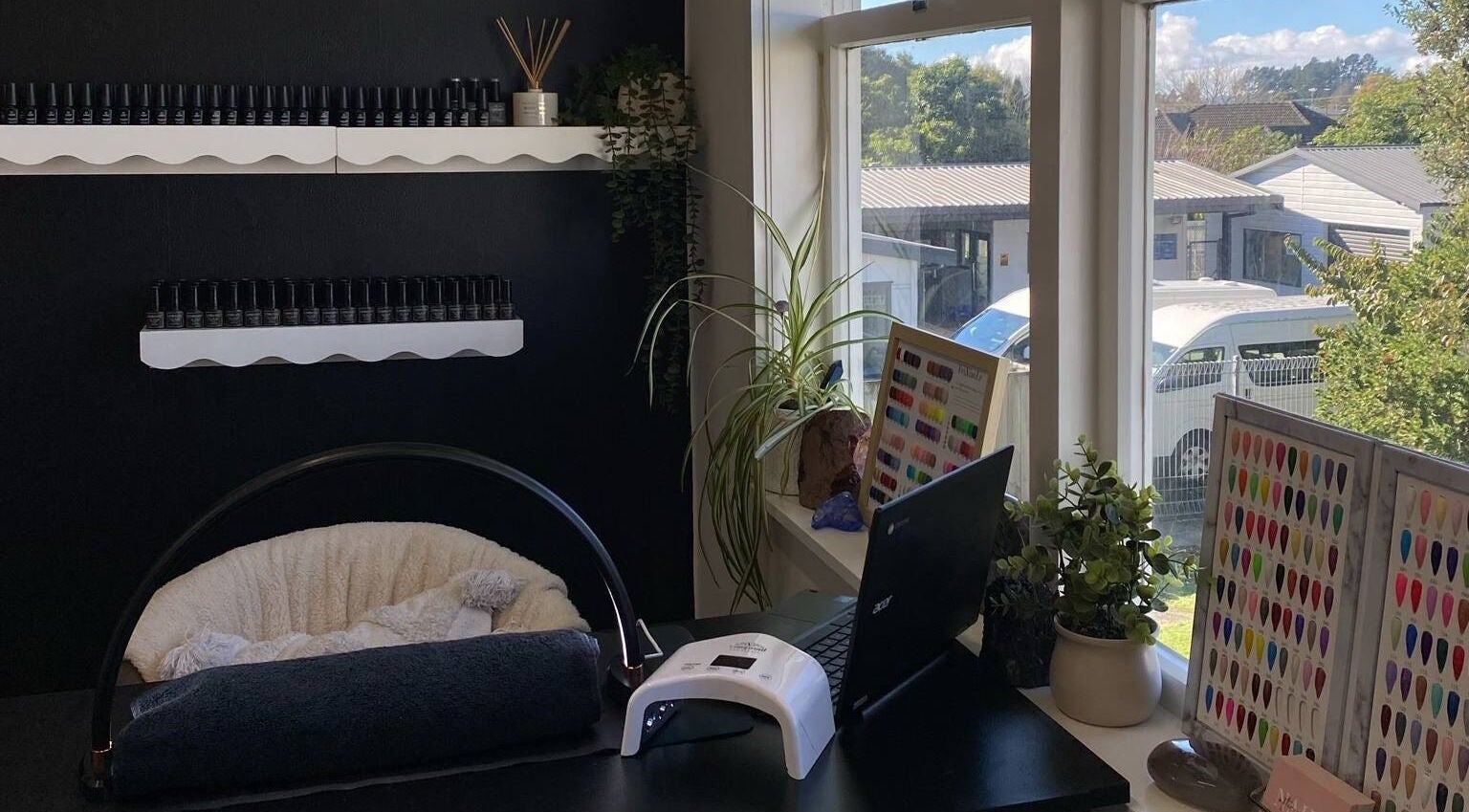 Chic nail setup at Regz Boutique, Kawerau, Bay Of Plenty Region, NZ with polish display and manicure table.