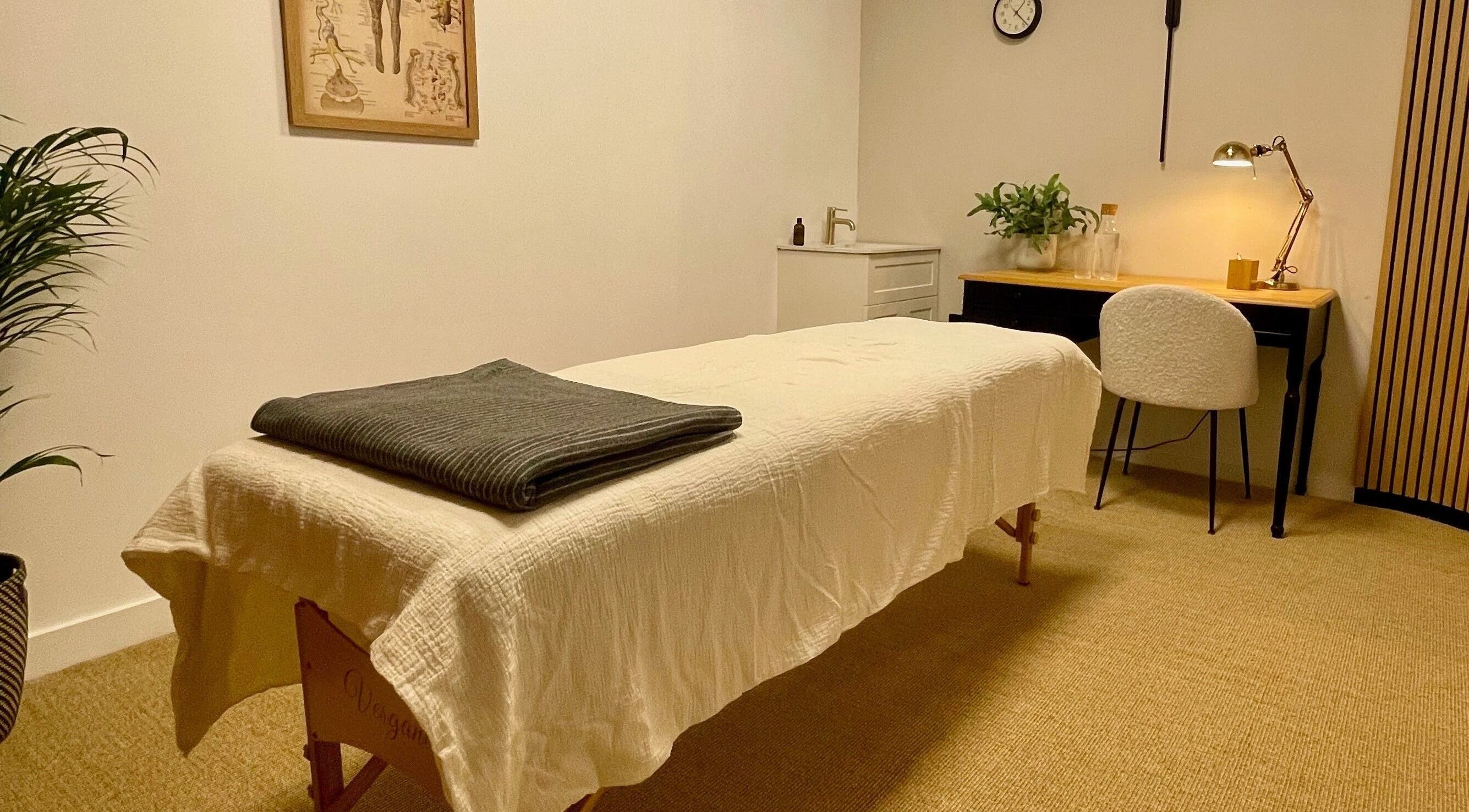 Cozy treatment room at Face by Melissa Queen's Park, London, England, GB, with a massage table and ambient lighting.