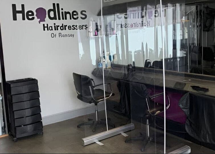 Chic salon interior at The Hair Project, Ramsey, England, GB featuring stylish chairs and mirrors.