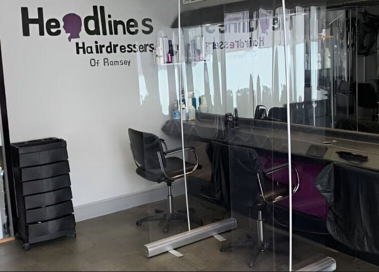 Chic salon interior at The Hair Project, Ramsey, England, GB featuring stylish chairs and mirrors.