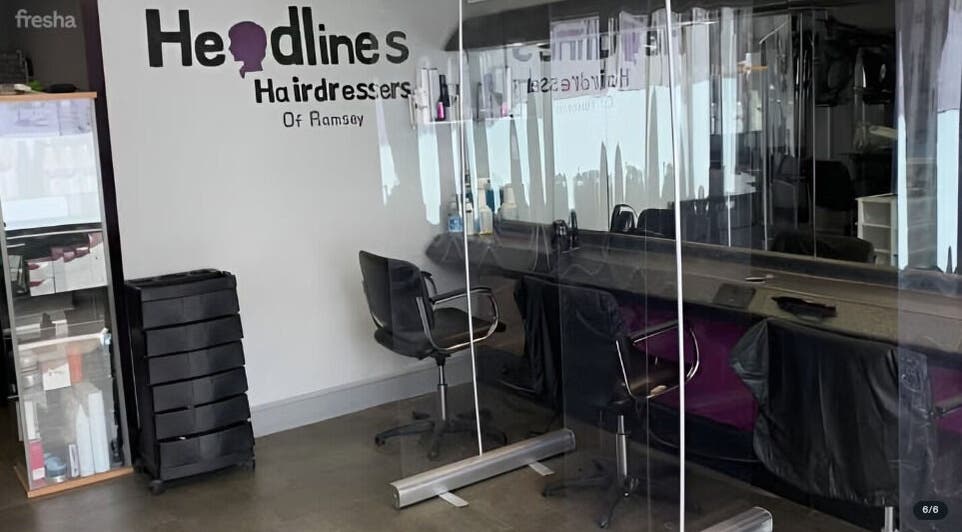 Chic salon interior at The Hair Project, Ramsey, England, GB featuring stylish chairs and mirrors.